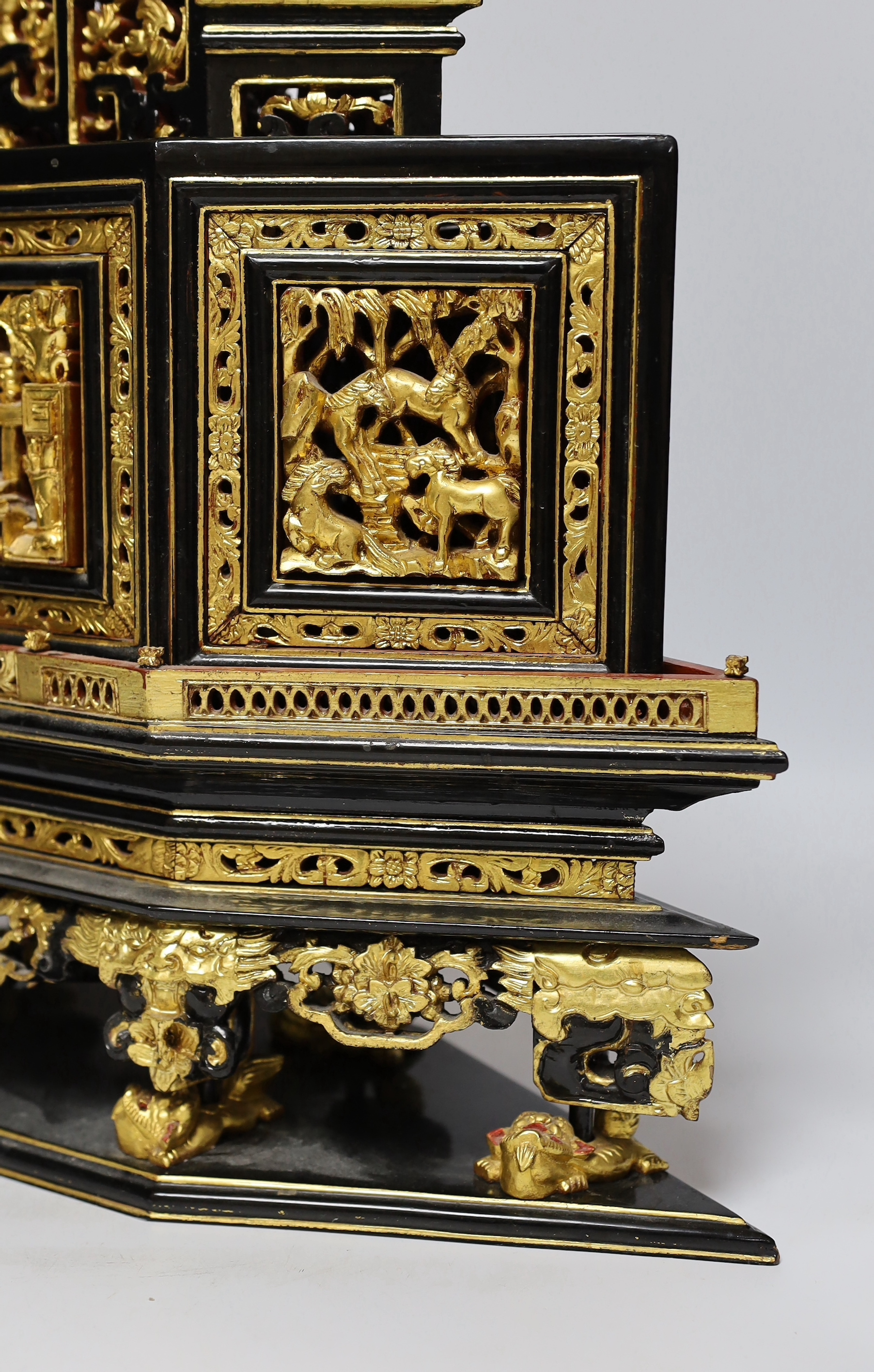 A 20th century Chinese carved lacquered wood altar stand, 49cm wide